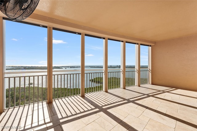 unfurnished sunroom with a water view