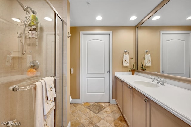 bathroom with vanity and a shower with door