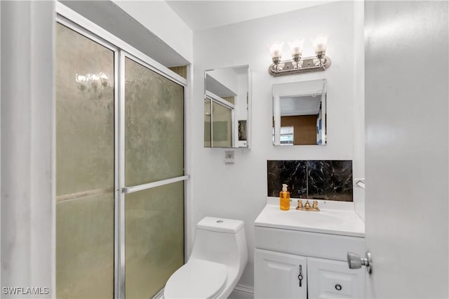 bathroom featuring walk in shower, vanity, and toilet