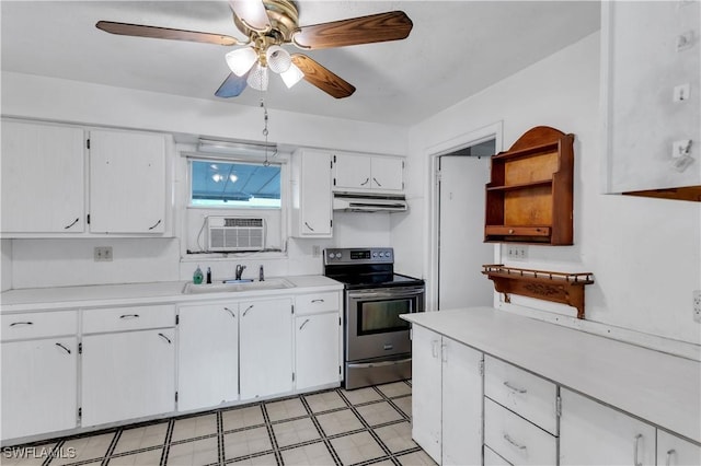 kitchen with stainless steel range with electric cooktop, white cabinets, sink, ceiling fan, and a wall unit AC