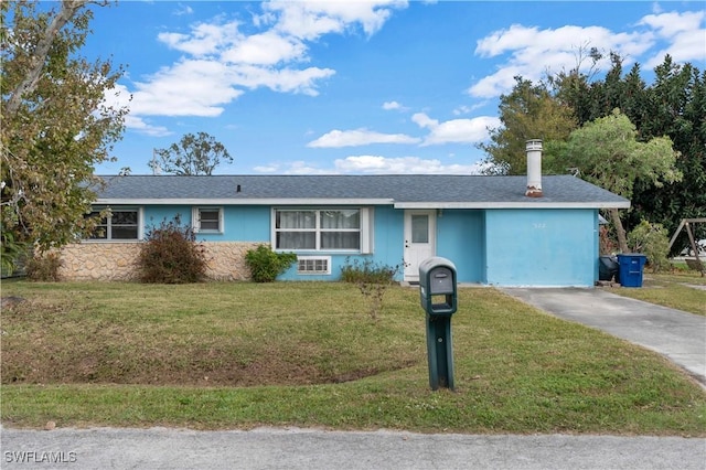 ranch-style house with a front lawn