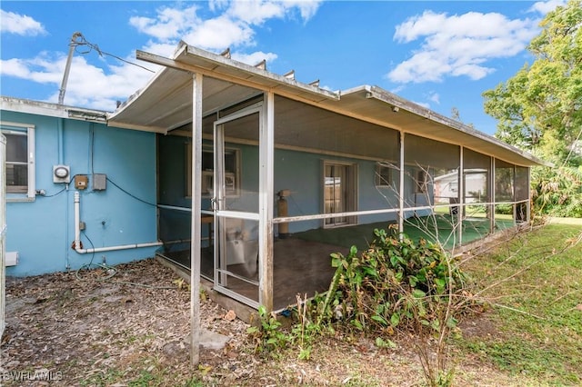 view of side of home with a sunroom