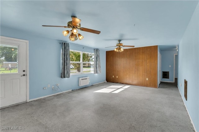 unfurnished living room with a wall mounted AC and ceiling fan