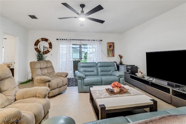 tiled living room with ceiling fan