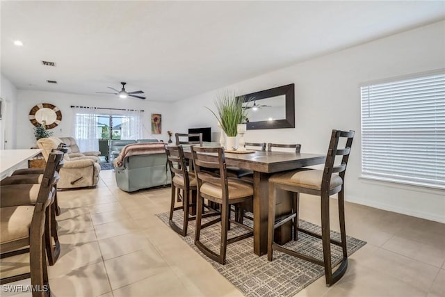 dining area featuring light tile patterned floors and ceiling fan