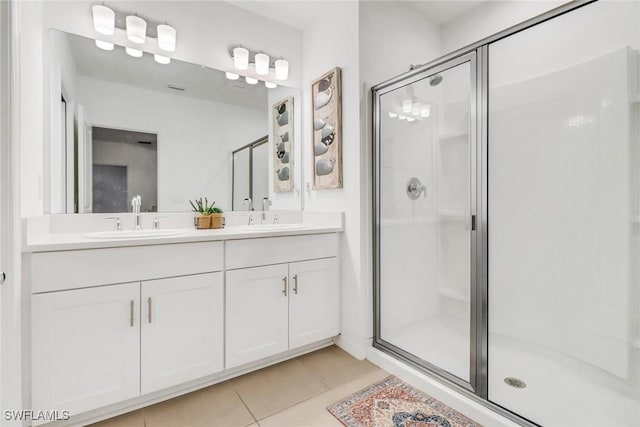 bathroom featuring tile patterned floors, vanity, and walk in shower