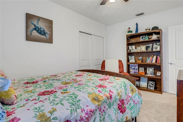 carpeted bedroom featuring ceiling fan and a closet