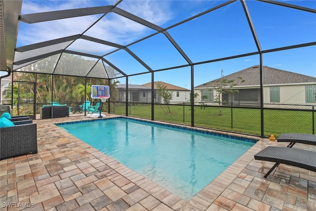 view of pool with a lawn, a lanai, and a patio