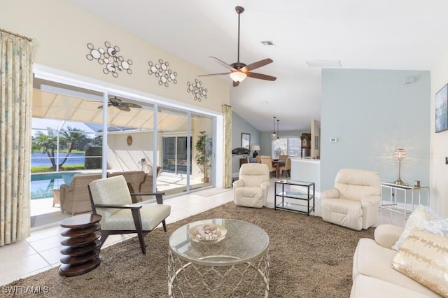 living room featuring a wealth of natural light, light tile patterned flooring, and high vaulted ceiling