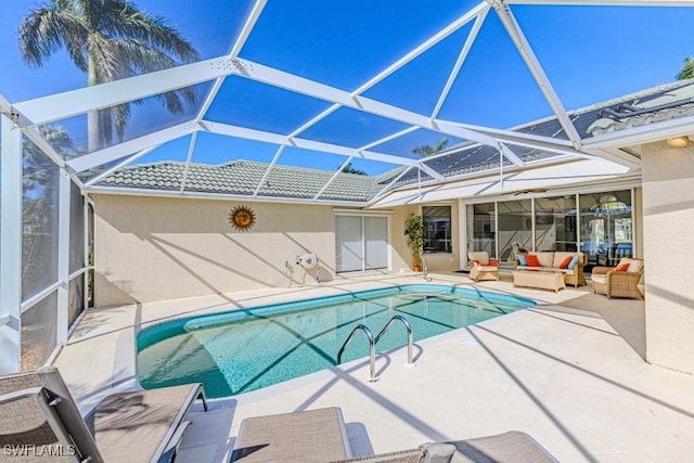 view of pool featuring outdoor lounge area, glass enclosure, and a patio