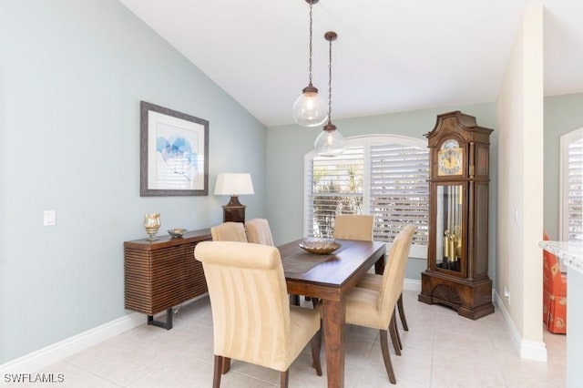 tiled dining area with vaulted ceiling