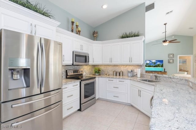 kitchen with appliances with stainless steel finishes, white cabinetry, and sink