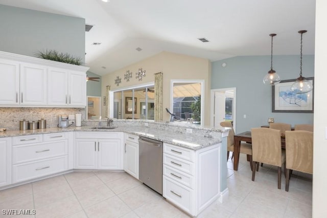 kitchen featuring dishwasher, vaulted ceiling, and white cabinetry