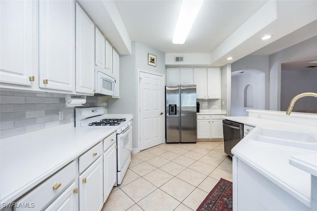 kitchen featuring visible vents, appliances with stainless steel finishes, white cabinetry, a sink, and light tile patterned flooring