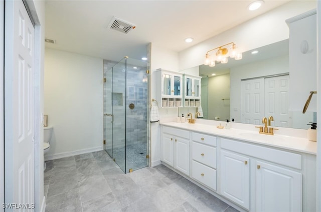 full bathroom with double vanity, visible vents, toilet, a stall shower, and a sink