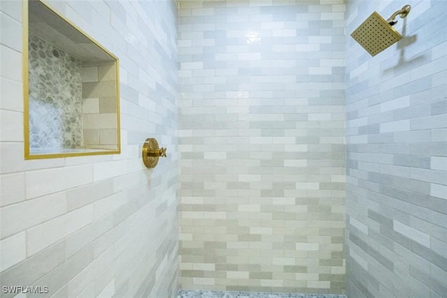 bathroom with a tile shower