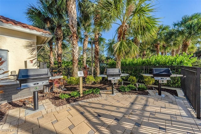 view of patio / terrace with area for grilling and fence