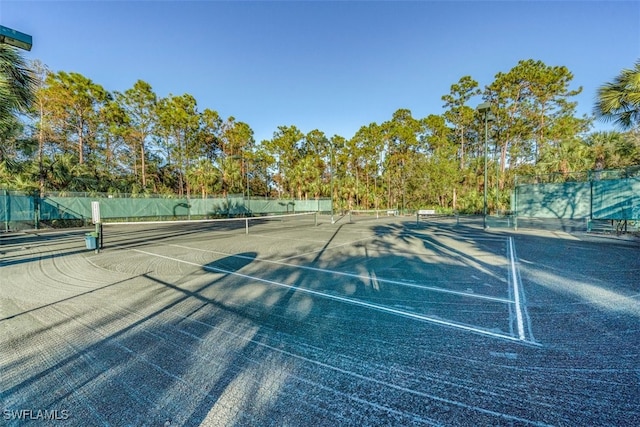 view of sport court with fence