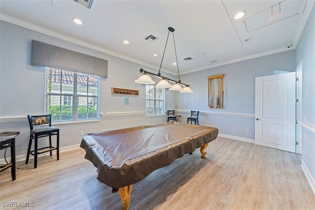 rec room with ornamental molding, plenty of natural light, baseboards, and wood finished floors