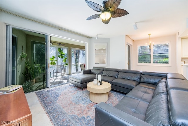 living room with a healthy amount of sunlight, light tile patterned floors, and a ceiling fan