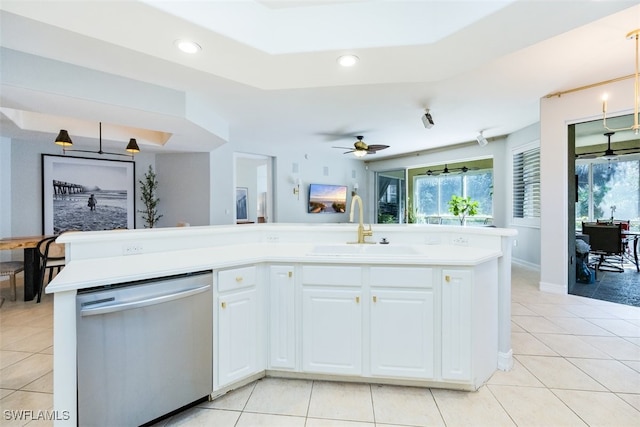 kitchen featuring a sink, a healthy amount of sunlight, light tile patterned floors, and stainless steel dishwasher