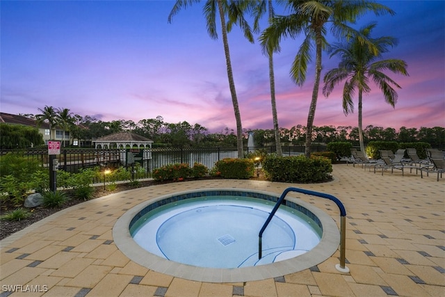 view of pool featuring a patio area, a hot tub, and fence