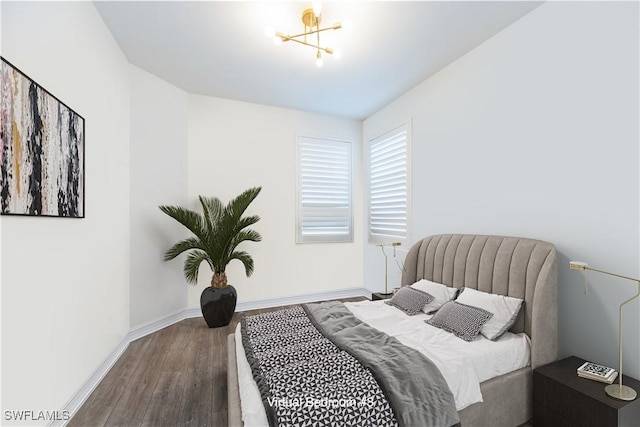 bedroom with baseboards and wood finished floors