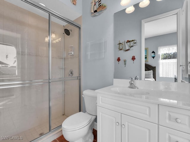 bathroom with vanity, toilet, and a shower with shower door