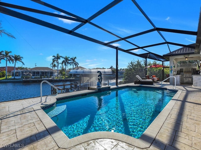 view of pool featuring a water view, area for grilling, glass enclosure, and a patio area