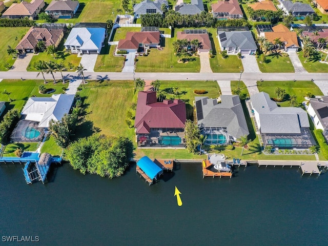 birds eye view of property with a water view