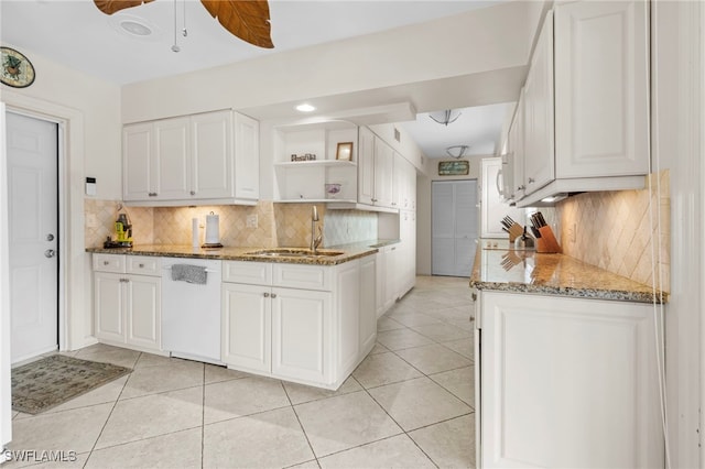 kitchen with dishwasher, white cabinetry, and stone counters