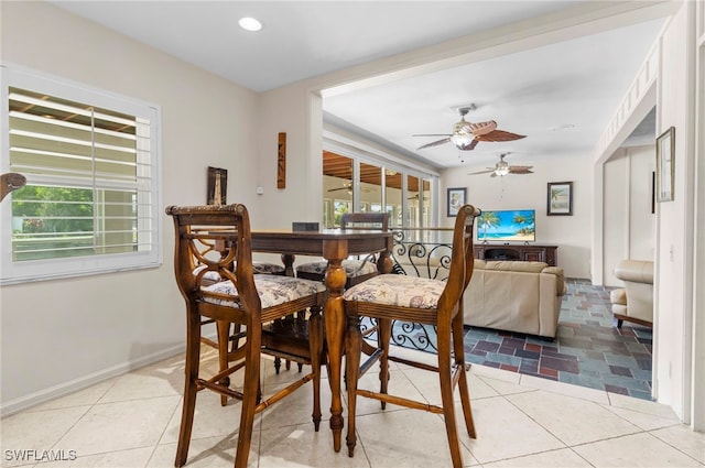 dining space featuring ceiling fan, light tile patterned flooring, and a healthy amount of sunlight