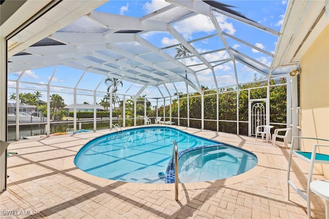 view of swimming pool featuring a lanai, a water view, a patio, and an in ground hot tub