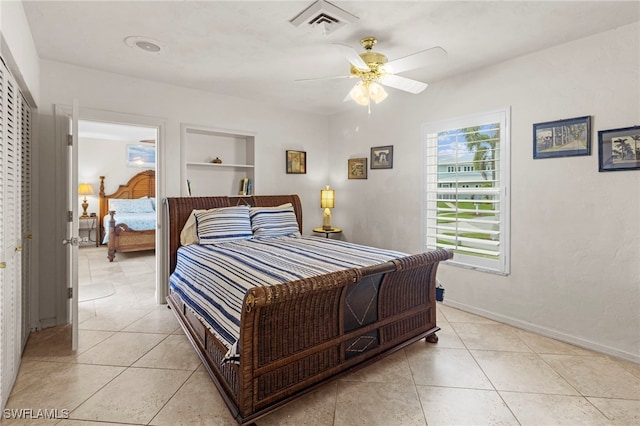 tiled bedroom with a closet and ceiling fan