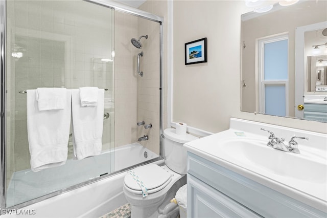 full bathroom featuring vanity, toilet, and bath / shower combo with glass door