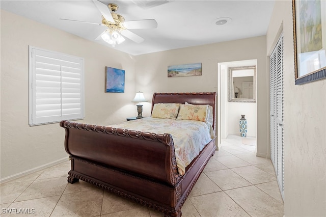 tiled bedroom with ceiling fan and a closet