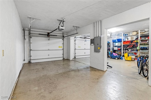 garage featuring electric panel and a garage door opener