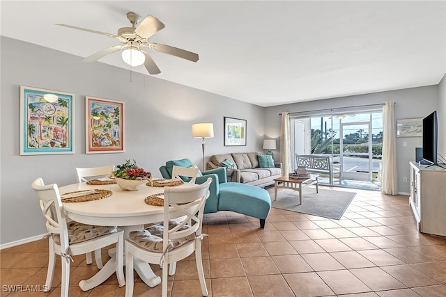 tiled dining space with ceiling fan