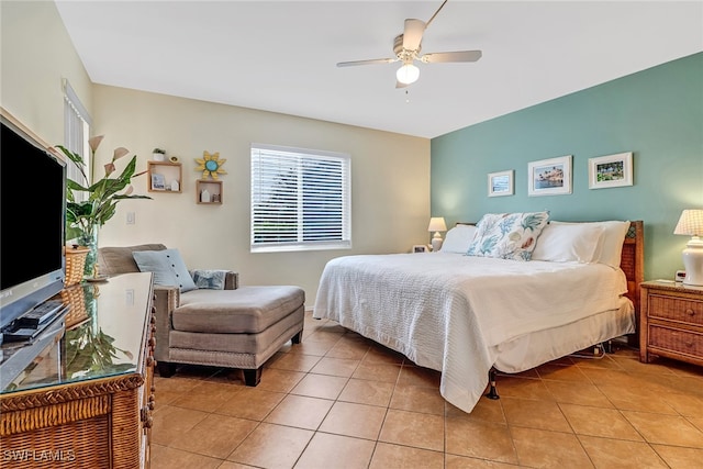 bedroom with ceiling fan and light tile patterned flooring