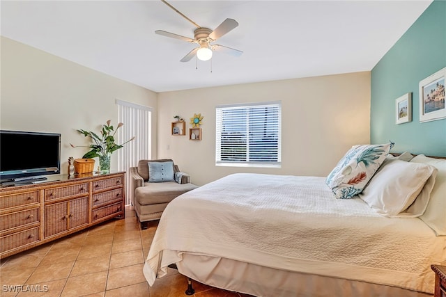 tiled bedroom featuring ceiling fan