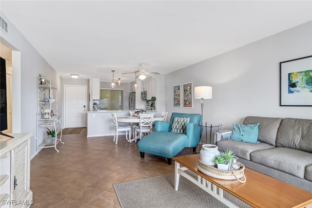 living room with tile patterned floors and ceiling fan