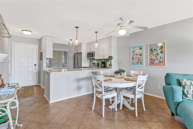 dining area featuring ceiling fan and light tile patterned flooring