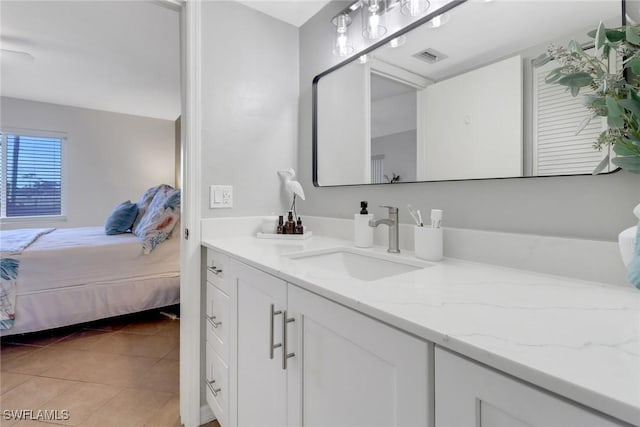 bathroom featuring tile patterned flooring and vanity