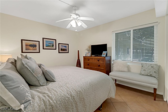 tiled bedroom featuring ceiling fan