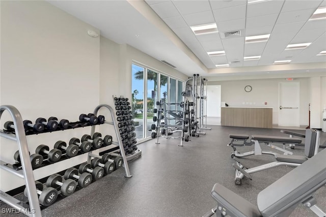 gym with a paneled ceiling