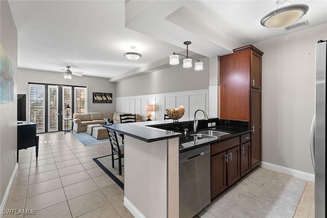 kitchen featuring kitchen peninsula, ceiling fan, sink, and stainless steel appliances