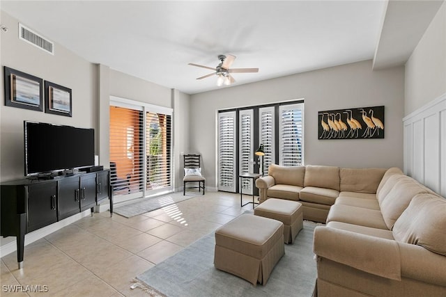 tiled living room featuring ceiling fan