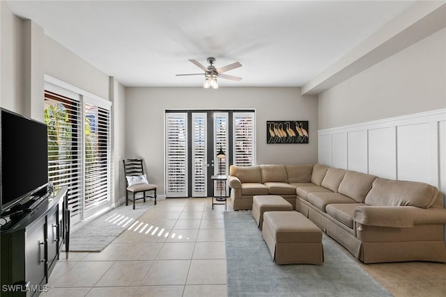 living room with ceiling fan and light tile patterned floors