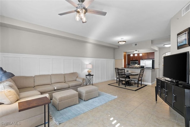 living room with ceiling fan and light tile patterned flooring