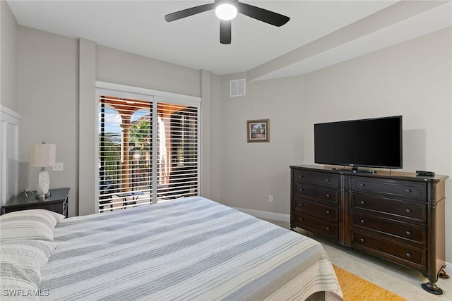 tiled bedroom featuring ceiling fan